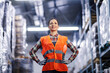 © Dusan Petkovic - A proud female warehouse worker standing at workplace ready for work.