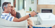 © Yuri Arcurs/peopleimages.com - Chilled out in front of the TV. Shot of mature couple cuddling on the sofa while watching movies at home.