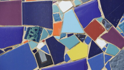 Colorful abstract ceramic mosaic. Close up. Mosaic on the wall with fragments of blue, white, black colors with pieces.