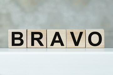 BRAVO word written on wood blocks on the a table