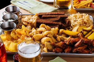 Wall Mural - Closeup on assorted salty snacks set on the table