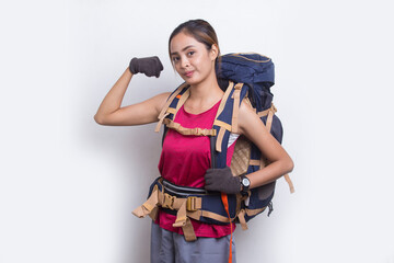 Young beautiful hiker asian woman with a backpack making strong gesture isolated on white background
