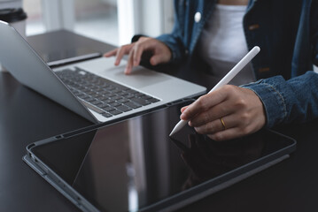 Poster - Close up of business woman in casual wear using stylus pen touching on digital tablet screen on office desk at home. Female entrepreneur, freelancer working on tablet pc