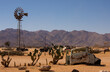 Old rusty vehicle and a windmill with prickly pear cactus at Solitare