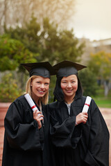 Wall Mural - Were ready for our next adventure. Shot of two college graduates holding their diplomas.