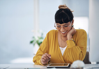 Sticker - Updating my schedule for tomorrow. Cropped shot of an attractive young businesswoman sitting alone in her office and using a tablet.