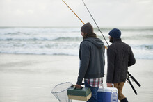 Packed And Ready To Fish. Shot Of A Two Friends Going Fishing On An Early Overcast Morning.