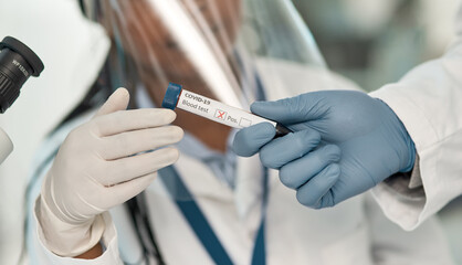 Wall Mural - the result is confirmed. closeup shot of an unrecognisable scientist holding a blood filled test tub
