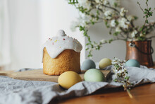 Happy Easter!  Homemade Easter Bread, Natural Dyed Eggs And Spring Blossom On Rustic Table In Room. Stylish Freshly Baked Easter Cake With Sugar Glaze And Sprinkles, Traditional Ukrainian Bun