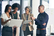 © Anne/peopleimages.com - Guiding their company to the best future possible. Shot of a team of colleagues using modern technology during an informal meeting.