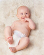 © Tabitha R/peopleimages.com - Hes his moms little angel. Cropped shot of an adorable baby boy in a studio.