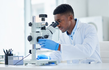 what an interesting find. cropped shot of a focused young male scientist looking at test samples thr