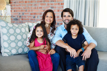 Poster - My happy family. A young family sitting on the couch together in their living room.