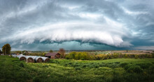 Supercell Storm Over A Farm With Hay Bales
