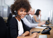 © Mikolette Moller/peopleimages.com - Service with a smile. Portrait of an attractive young female call center operator.