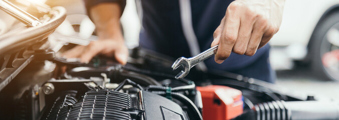 Automobile mechanic repairman hands repairing a car engine automotive workshop with a wrench, car service and maintenance,Repair service.