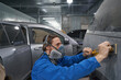 Male in respirator hard working in garage