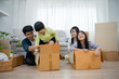 © Shisu_ka - Asian family smiles and laughs happily in new home. Adorable sons and daughters play with boxes while moving house. family day activities together