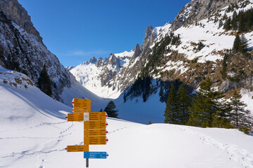 Bruelisau, Appenzell Switzerland, 02-23-2022,
sign post with many hiking destinations in the Alpstein mountain range near Appenzell in Switzerland