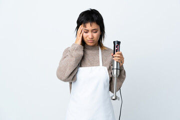 Wall Mural - Chef Uruguayan girl using hand blender over isolated white background unhappy and frustrated with something. Negative facial expression