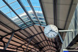 analogue clock in the MRT sky train station or train platform in Bangkok, Thailand. interior ceiling of train platform showing sky windows and roof material. travel or journey concept.