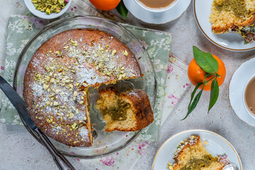 Canvas Print - Pistachio and orange cake sprinkled with icing sugar and crushed pistachio nuts