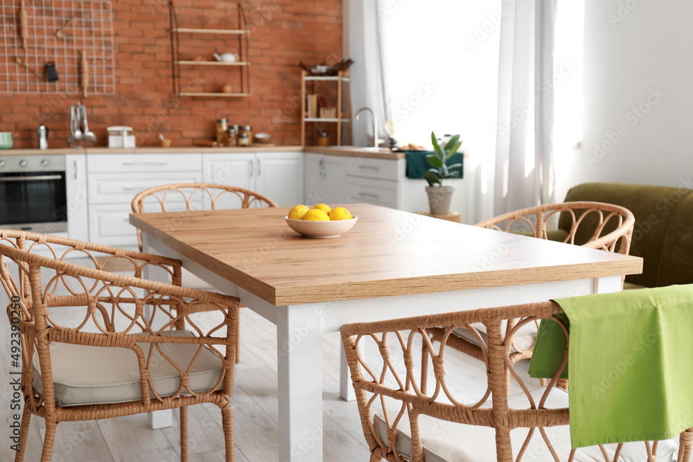 Dining table and chairs in stylish kitchen interior
