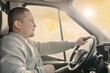 © velimir - young male truck driver on a  rides behind the wheel