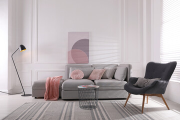 Wall Mural - Cozy living room interior with comfortable grey sofa and armchair