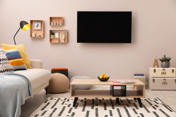 Sticker - Modern TV, comfortable sofa and decor elements in living room