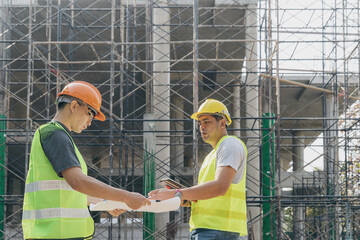 Wall Mural - Confident team of architect working together in building construction site. They discussing about new startup project. Architect discuss with engineer about project . Architectural concept.