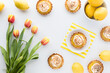 © Carey - An arrangement of lemon meringue tartlets, lemons and tulips.