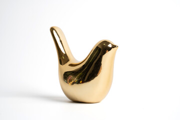 golden ceramic bird on white isolated