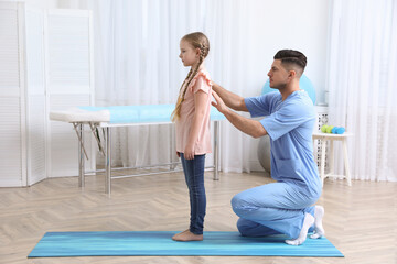 Sticker - Orthopedist examining child's back in clinic. Scoliosis treatment