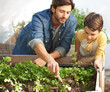 © Tylan E/peopleimages.com - Giving each plant special attention. Shot of a father and son tending to the plants in their herb garden.