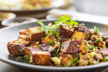 Wall Mural - Stir-fried black tofu with chili, salt, garlic and pepper. Authentic the rare black tofu found only in Ratchaburi, Photharam Village, Thailand. Balance salty and sweet stew with sweet herbal gravy.