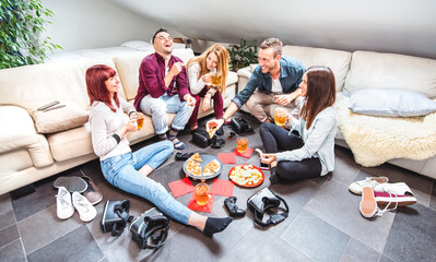 Millenial friends drinking beer at home party after work - Tech life style friendship concept with roommates students enjoying time having fun and eating together at shared apartment - Bright filter