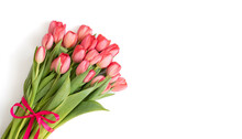 Bouquet Of Pink Tulips With Bow Isolated On White Background. Beautiful Spring Flowers. Valentines Day, Mothers Day Concept. Copy Space, Top View, Flat Lay.