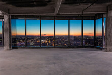 Beautiful Sunset Seen Through Floor To Ceiling Windows In Undeveloped Office Space In High-rise In Urban Setting