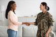 © Prostock-studio - Black Psychotherapist Woman Handshaking With Smiling Soldier Lady During Meeting In Office