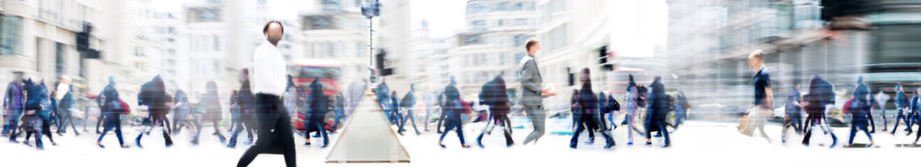 Wall Mural - People walking in the City, blurred wide background representing modern fast moving life in the capital City. People crossing the road. 