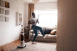 The vacuum is my favorite instrument. Shot of a young man dancing while busy vacuuming the living room.