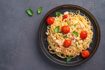 Wall Mural - Fetapasta of oven-baked feta cheese, cherry tomatoes, garlic and herbs.