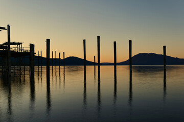 Wall Mural - Long exposure at clear lake at sunrise showing old boat docks