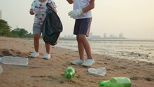 Volunteer Happy Family Kids Picking Plastic Bottle Into Trash Plastic Bag Black For Cleaning Beach, Children Clean Up Garbage At Sunset, Ecology And World Environment Day, Save Earth Concept