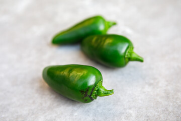 Wall Mural - Fresh, hot green jalapeno chili peppers harvested from a home organic garden