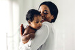 © Art_Photo - Portrait of enjoy happy love family african american mother playing with adorable little african american baby.Mom kiss with cute son moments good time in a white bedroom.Love of black family