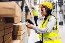 Portrait Of African American Engineer Woman Scanning Package With Barcode Scanner Check Goods In Transportation And Distribution In Warehouse.logistic Industrial And Business Export