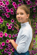 © Сергей Васильченко - A teenage girl against a background of flowers.