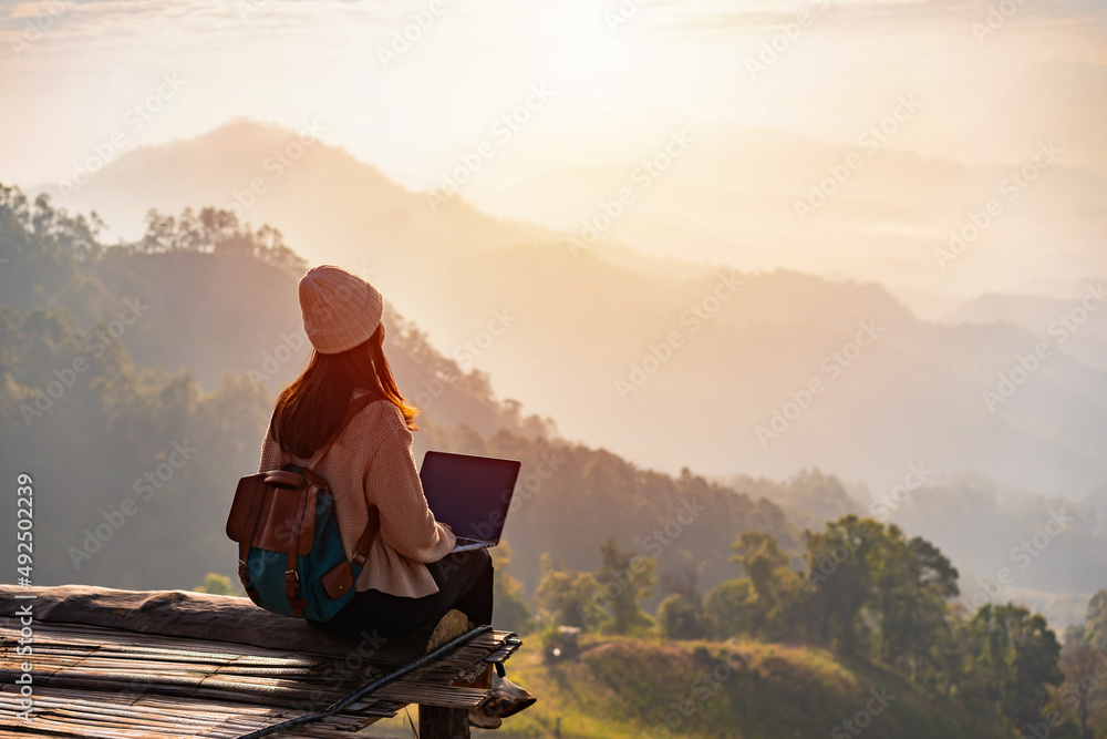 Young woman freelancer traveler working online using laptop and ...